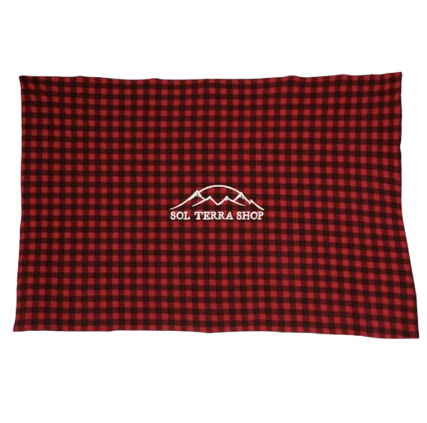 Red and black checkered blanket with a logo on a white background