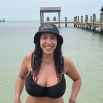 girl in ocean with bucket hat