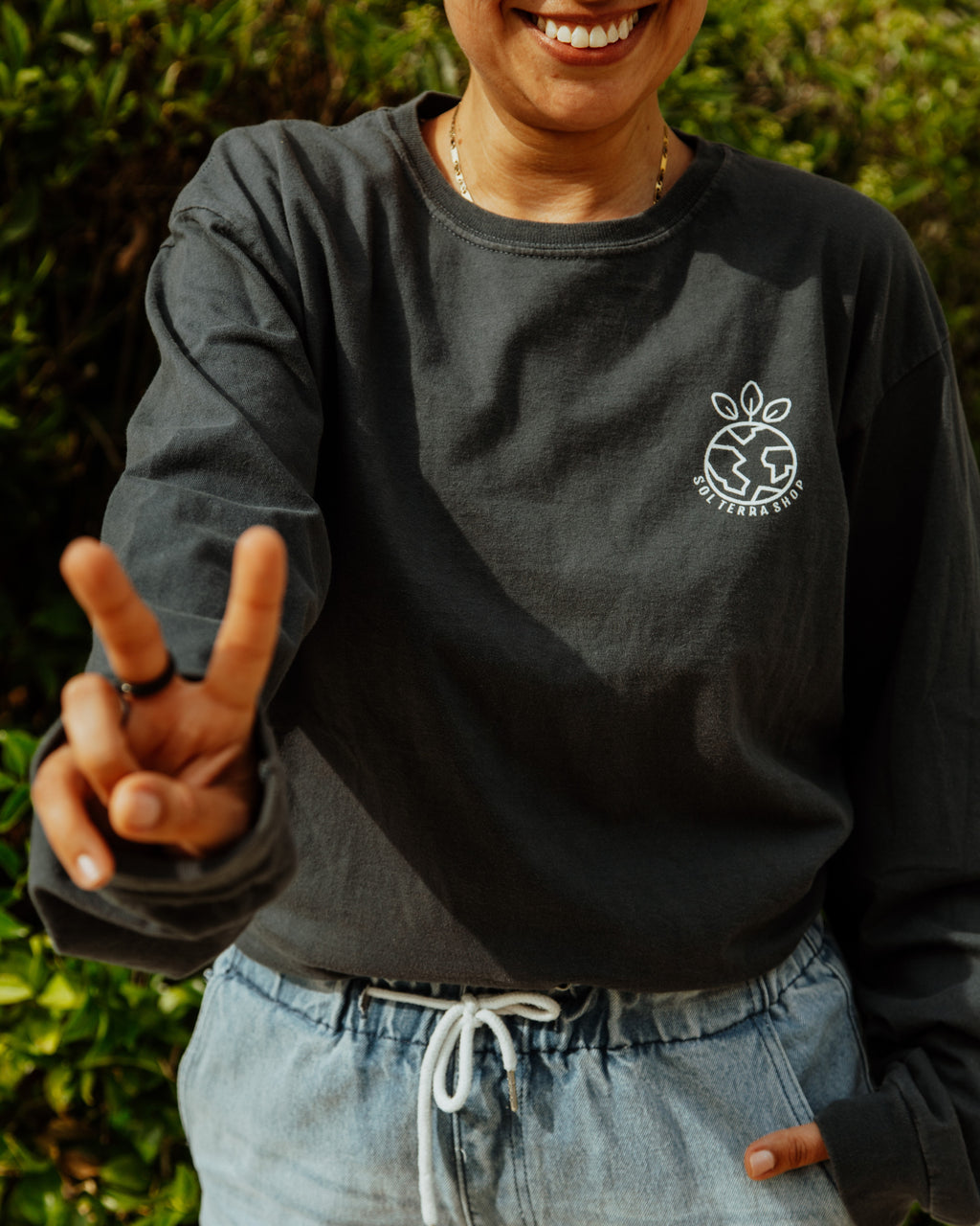 woman wearing Earth Day long sleeve