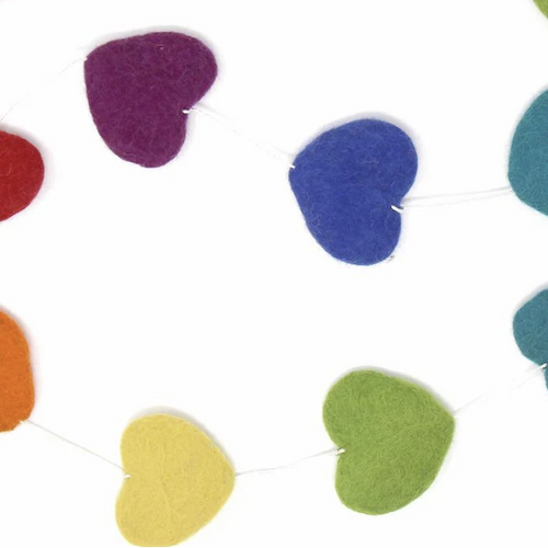close up of colorful hearts made of felt on the garland