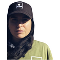 Person wearing a black hemp baseball cap with the sol terra shop logo embroidered on it