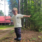 boy playing in the woods